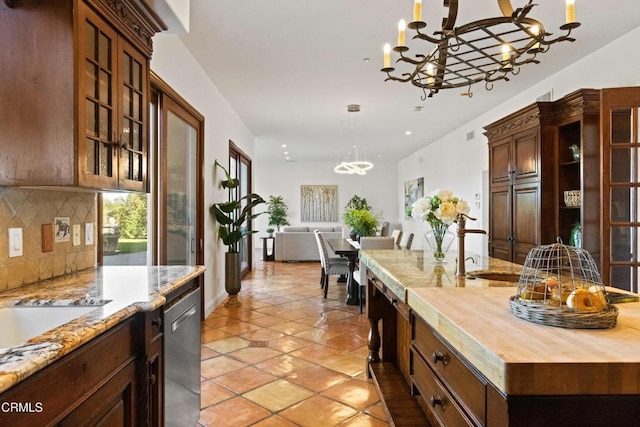 13045 Ripple Creek Ln, Camarillo, CA 93012 - kitchen featuring a chandelier, decorative backsplash, butcher block countertops, pendant lighting, and dishwasher