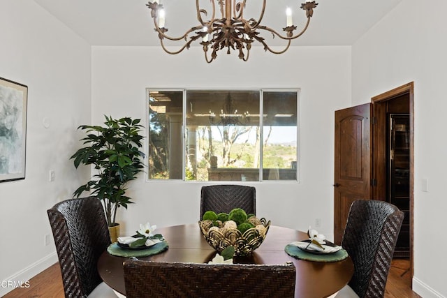 13045 Ripple Creek Ln, Camarillo, CA 93012 - dining space featuring a chandelier, wood finished floors, and baseboards