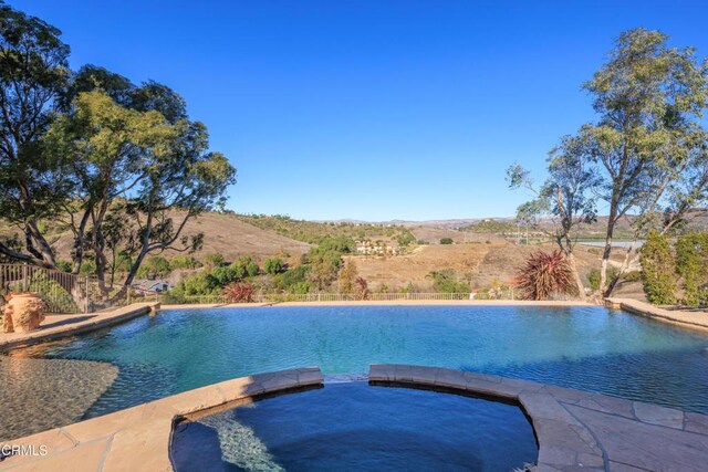 13045 Ripple Creek Ln, Camarillo, CA 93012 - view of swimming pool with a pool with connected hot tub and a mountain view