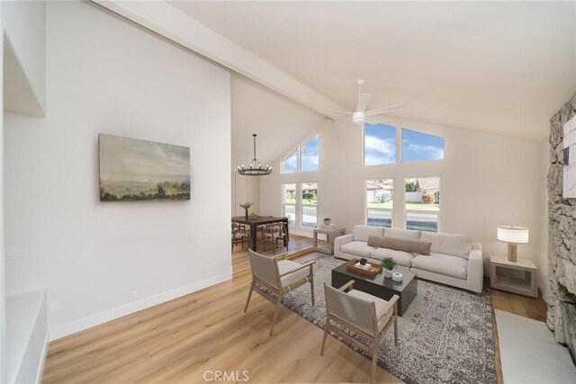 40033 Sagewood Dr, Palm Desert, CA 92260 - living area with wood finished floors, ceiling fan, high vaulted ceiling, baseboards, and a chandelier