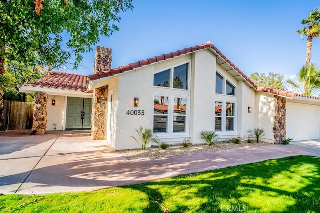 40033 Sagewood Dr, Palm Desert, CA 92260 - mediterranean / spanish home with a tile roof, stucco siding, stone siding, and a chimney