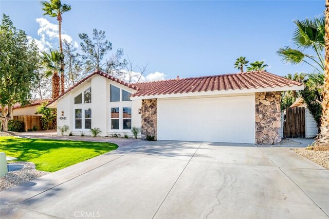40033 Sagewood Dr, Palm Desert, CA 92260 - view of front of property with stone siding, a tiled roof, driveway, and stucco siding