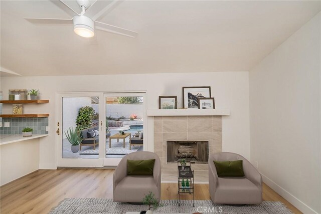 40033 Sagewood Dr, Palm Desert, CA 92260 - living area featuring wood finished floors, a fireplace, a ceiling fan, and baseboards