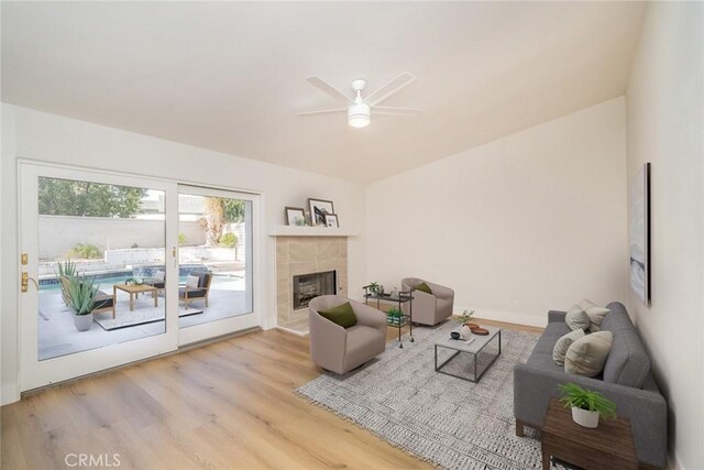 40033 Sagewood Dr, Palm Desert, CA 92260 - living area featuring ceiling fan, wood finished floors, a tile fireplace, and baseboards