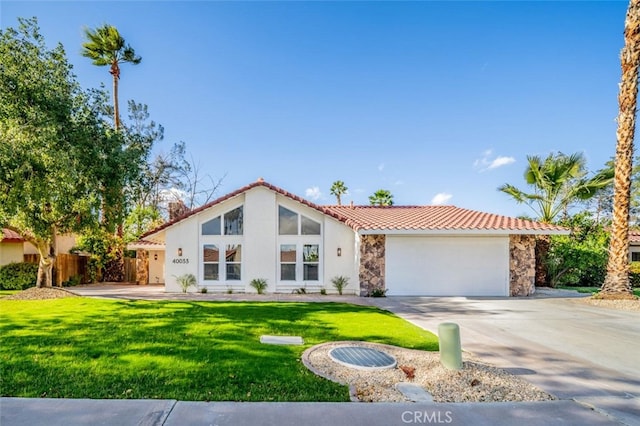 40033 Sagewood Dr, Palm Desert, CA 92260 - view of front of property featuring a tile roof, an attached garage, stone siding, driveway, and stucco siding