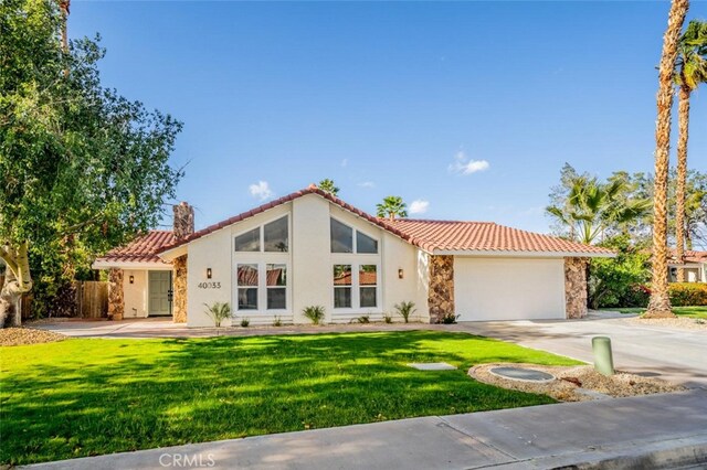 40033 Sagewood Dr, Palm Desert, CA 92260 - view of front facade with a tiled roof, stucco siding, stone siding, a garage, and driveway