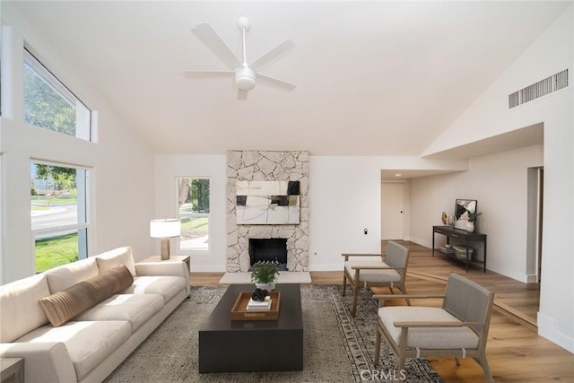 40033 Sagewood Dr, Palm Desert, CA 92260 - living area featuring high vaulted ceiling, wood finished floors, a fireplace, a ceiling fan, and baseboards