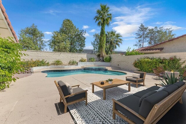 40033 Sagewood Dr, Palm Desert, CA 92260 - view of swimming pool with a fenced backyard, a patio, an outdoor living space, and a pool with connected hot tub