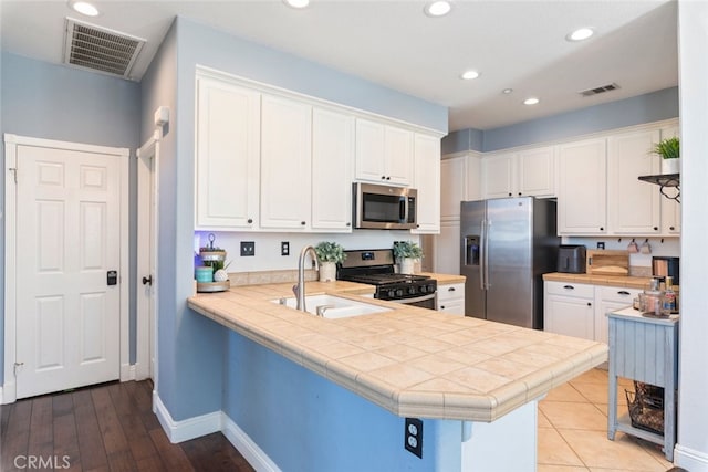29290 Morena Villa Dr, Highland, CA 92346 - kitchen with appliances with stainless steel finishes, a sink, white cabinetry, and recessed lighting