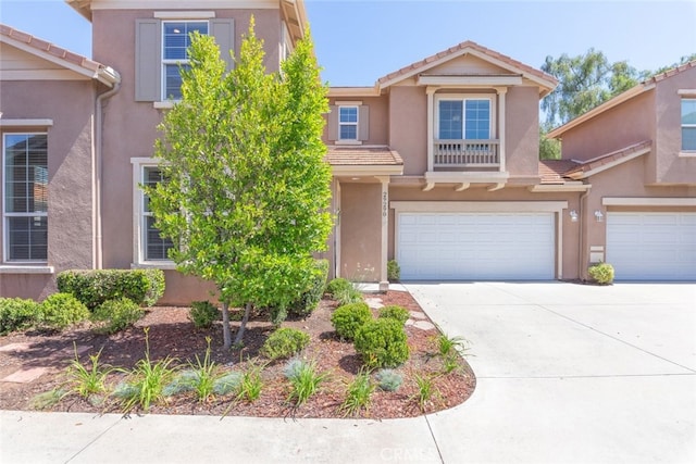 29290 Morena Villa Dr, Highland, CA 92346 - view of front of property with a garage, stucco siding, a tiled roof, and driveway