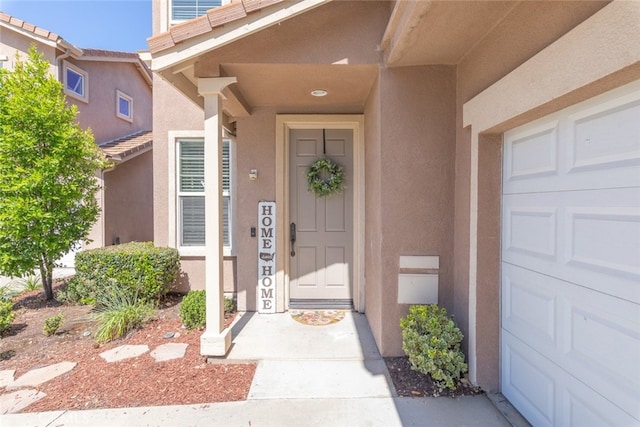 29290 Morena Villa Dr, Highland, CA 92346 - view of exterior entry featuring stucco siding and an attached garage