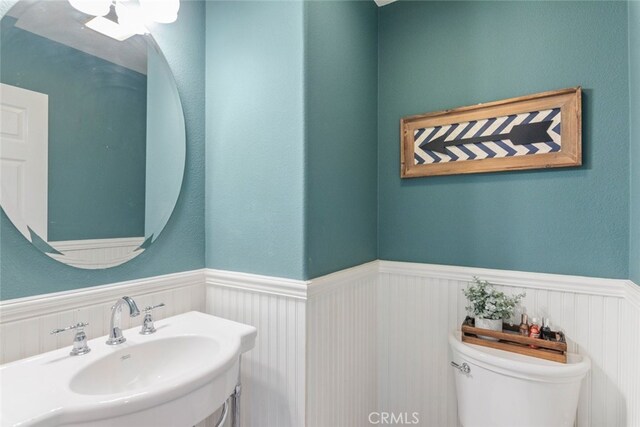 29290 Morena Villa Dr, Highland, CA 92346 - bathroom featuring wainscoting, a sink, and toilet