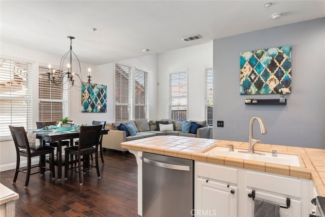29290 Morena Villa Dr, Highland, CA 92346 - kitchen featuring stainless steel dishwasher, a sink, dark wood-style flooring, a chandelier, and white cabinetry