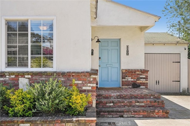 1120 9th St, Hermosa Beach, CA 90254 - doorway to property featuring stucco siding, stone siding, and an attached garage