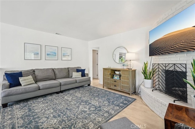 1120 9th St, Hermosa Beach, CA 90254 - living area with wood finished floors and a brick fireplace