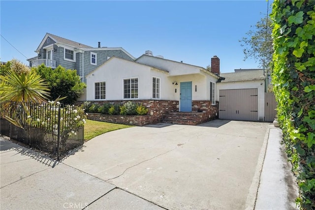 1120 9th St, Hermosa Beach, CA 90254 - view of front of house with concrete driveway, a garage, stucco siding, brick siding, and a chimney