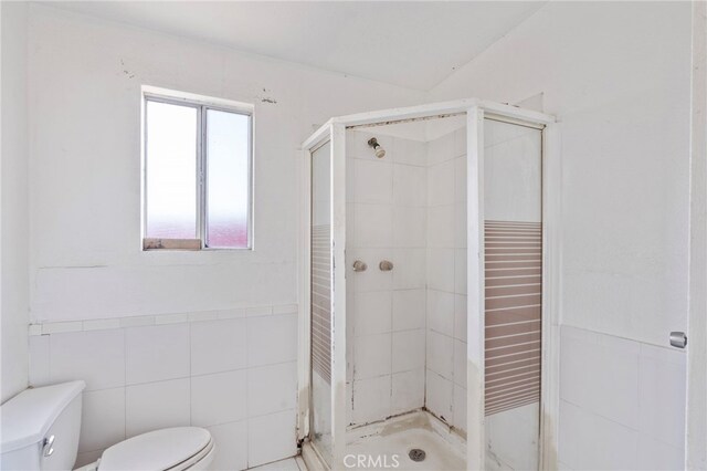 764 N Meridian Ave, Rialto, CA 92376 - bathroom with toilet, tile walls, and a stall shower