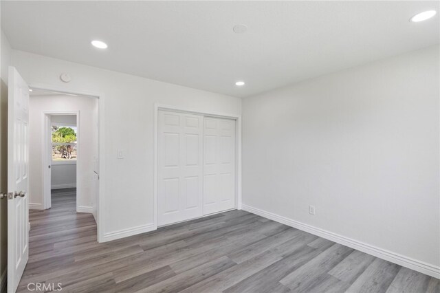 764 N Meridian Ave, Rialto, CA 92376 - unfurnished bedroom with wood finished floors, baseboards, recessed lighting, and a closet