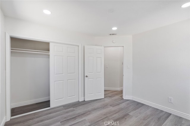 764 N Meridian Ave, Rialto, CA 92376 - unfurnished bedroom featuring wood finished floors, baseboards, a closet, and recessed lighting