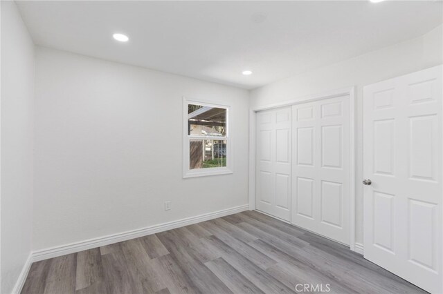 764 N Meridian Ave, Rialto, CA 92376 - unfurnished bedroom featuring wood finished floors, a closet, recessed lighting, and baseboards