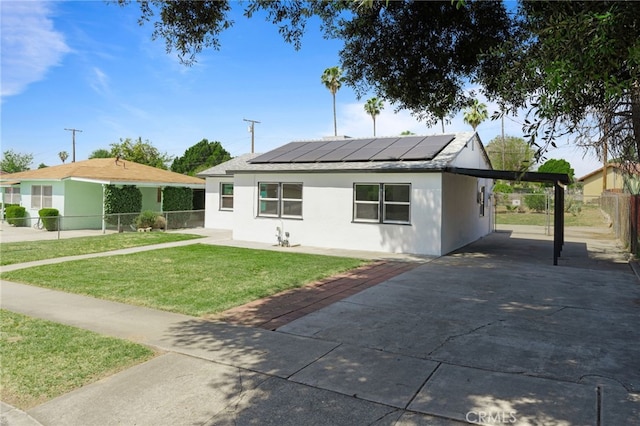 764 N Meridian Ave, Rialto, CA 92376 - view of front facade featuring solar panels, concrete driveway, an attached carport, and stucco siding