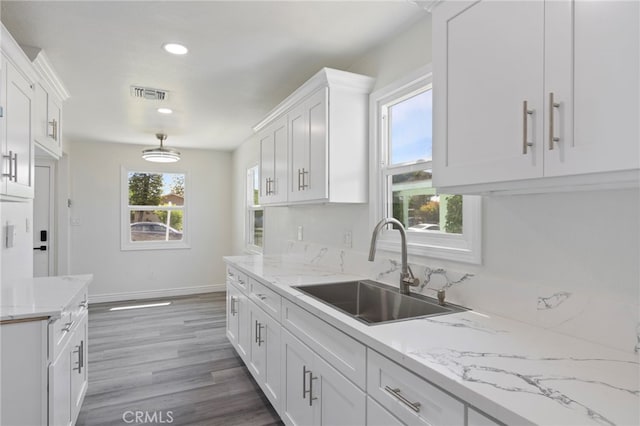 764 N Meridian Ave, Rialto, CA 92376 - kitchen with a sink, white cabinetry, recessed lighting, baseboards, and wood finished floors