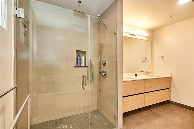 820 S Wilton Pl Unit 304, Los Angeles, CA 90005 - bathroom with double vanity, a shower stall, tile patterned floors, and baseboards