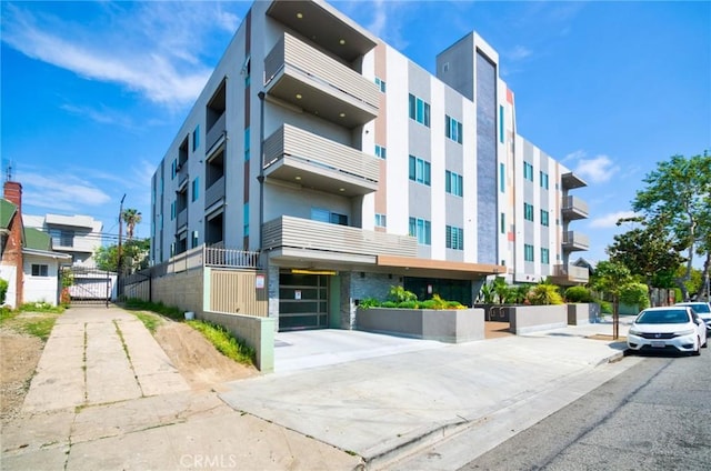820 S Wilton Pl Unit 304, Los Angeles, CA 90005 - view of property with an attached garage and concrete driveway