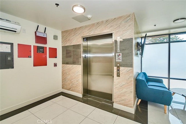 820 S Wilton Pl Unit 304, Los Angeles, CA 90005 - bathroom with elevator, a wall mounted air conditioner, tile patterned floors, and baseboards