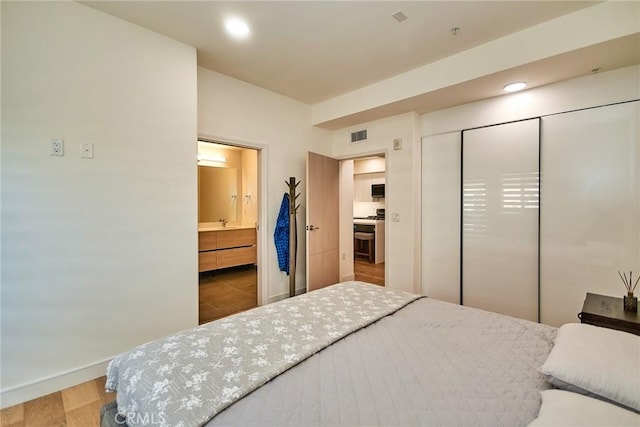 820 S Wilton Pl Unit 304, Los Angeles, CA 90005 - bedroom featuring wood finished floors, a closet, baseboards, recessed lighting, and ensuite bathroom