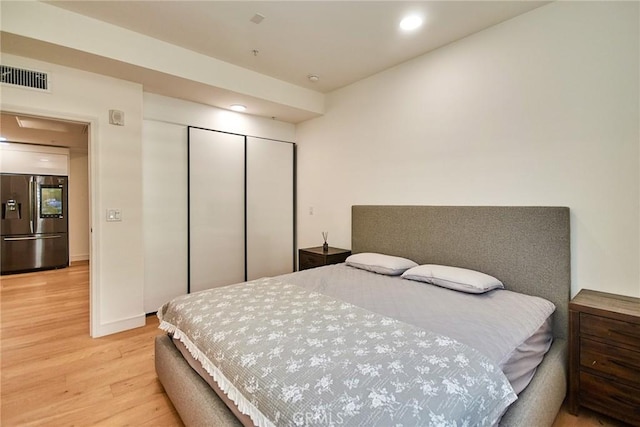820 S Wilton Pl Unit 304, Los Angeles, CA 90005 - bedroom featuring stainless steel fridge with ice dispenser, light wood-style flooring, a closet, and recessed lighting