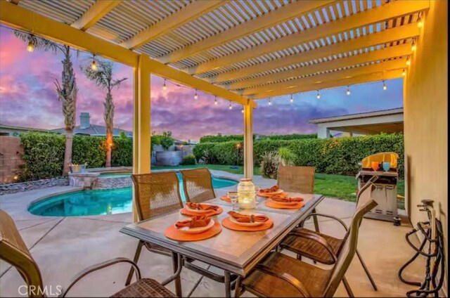 80804 Sunspring Ct, Indio, CA 92201 - patio terrace at dusk featuring a fenced backyard, a pergola, a patio area, and a pool with connected hot tub