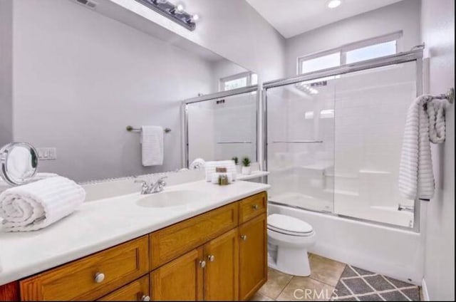 80804 Sunspring Ct, Indio, CA 92201 - full bath featuring vanity, toilet, shower / bath combination with glass door, and tile patterned floors