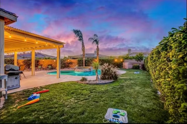80804 Sunspring Ct, Indio, CA 92201 - pool at dusk with a patio, a pool with connected hot tub, and area for grilling