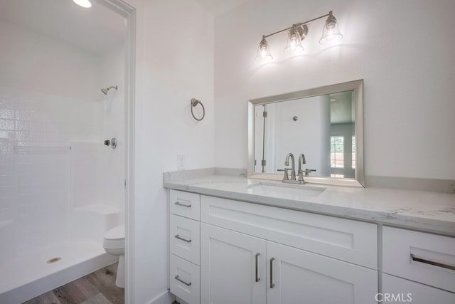 1264 W Etiwanda Ave, Rialto, CA 92376 - full bath with vanity, toilet, a tile shower, and wood finished floors