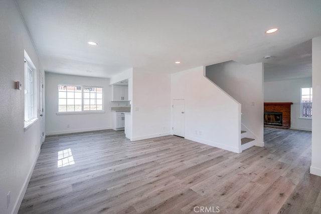 1264 W Etiwanda Ave, Rialto, CA 92376 - unfurnished living room with light wood-style floors, baseboards, healthy amount of natural light, and recessed lighting