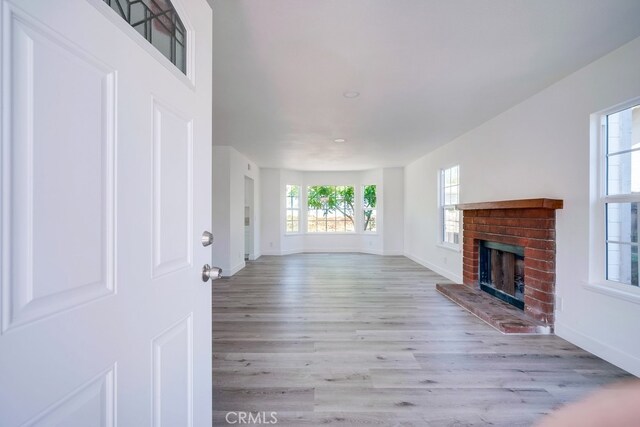 1264 W Etiwanda Ave, Rialto, CA 92376 - unfurnished living room featuring baseboards, a fireplace, wood finished floors, and recessed lighting