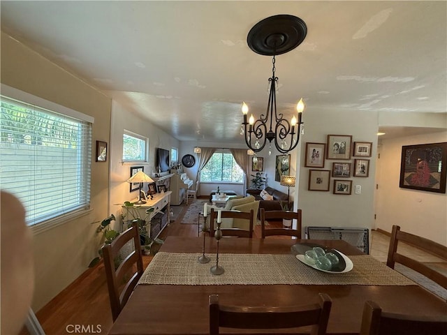 15911 Dundalk Ln, Huntington Beach, CA 92647 - dining room with a chandelier, wood finished floors, and baseboards