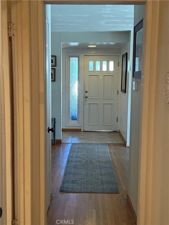 15911 Dundalk Ln, Huntington Beach, CA 92647 - entryway with baseboards and wood finished floors