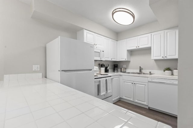 6955 Alvarado Rd Unit 77, San Diego, CA 92120 - kitchen with white appliances, a sink, tile counters, white cabinets, and dark wood-type flooring