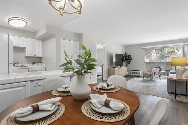 6955 Alvarado Rd Unit 77, San Diego, CA 92120 - dining space featuring wood finished floors and a chandelier