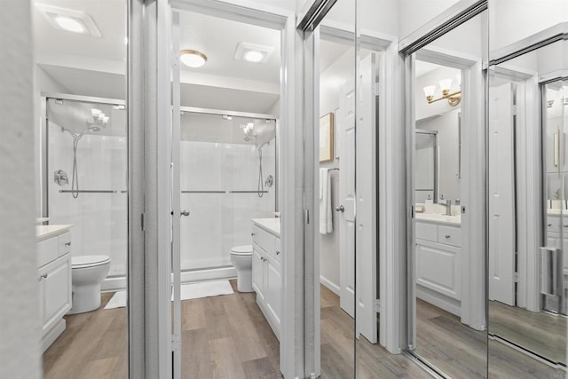 6955 Alvarado Rd Unit 77, San Diego, CA 92120 - bathroom featuring toilet, wood finished floors, vanity, and a stall shower