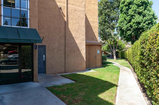 6955 Alvarado Rd Unit 77, San Diego, CA 92120 - view of home's exterior featuring stucco siding and a lawn