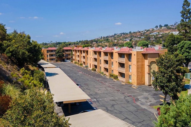 6955 Alvarado Rd Unit 77, San Diego, CA 92120 - view of building exterior with uncovered parking
