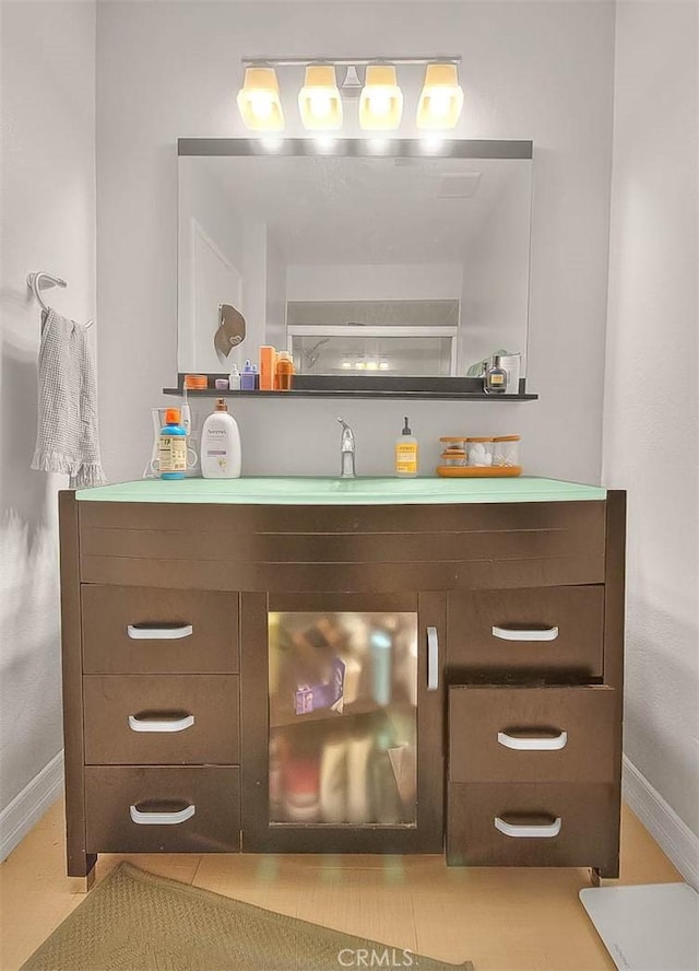 330 W California Blvd Unit 111, Pasadena, CA 91105 - bar area featuring baseboards and a sink