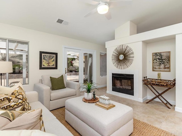 1219 Sunglow Dr, Oceanside, CA 92056 - living room featuring a ceiling fan, a tile fireplace, light tile patterned floors, baseboards, and lofted ceiling