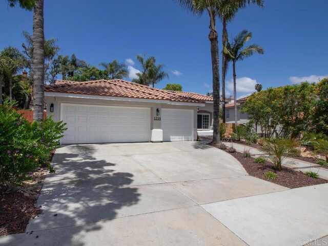 1219 Sunglow Dr, Oceanside, CA 92056 - mediterranean / spanish home with a tile roof, stucco siding, a garage, and driveway