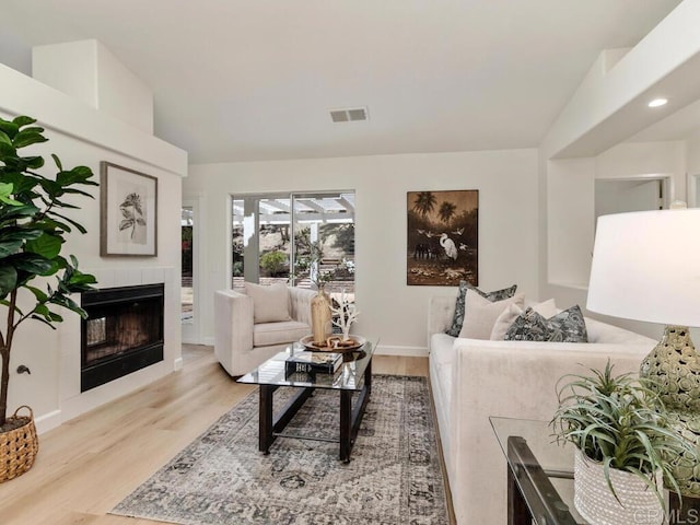 1219 Sunglow Dr, Oceanside, CA 92056 - living room with light wood-style floors, a tiled fireplace, and baseboards