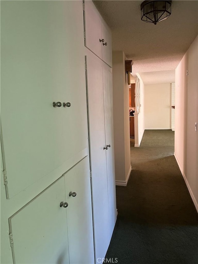 2306 S Rene Dr, Santa Ana, CA 92704 - hallway with dark carpet and baseboards