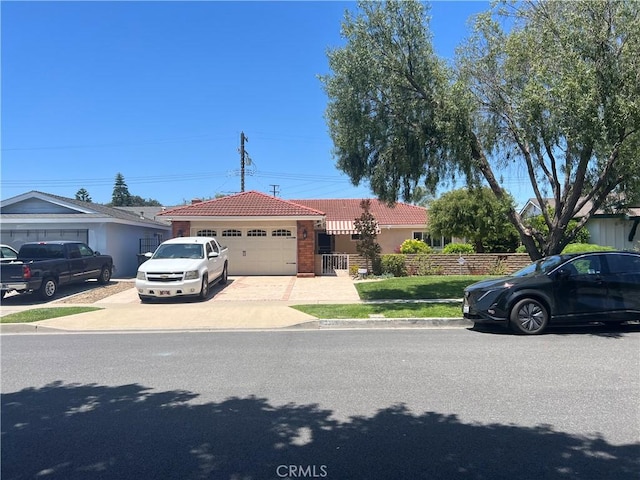 2306 S Rene Dr, Santa Ana, CA 92704 - view of front of house with a tile roof, an attached garage, driveway, and stucco siding
